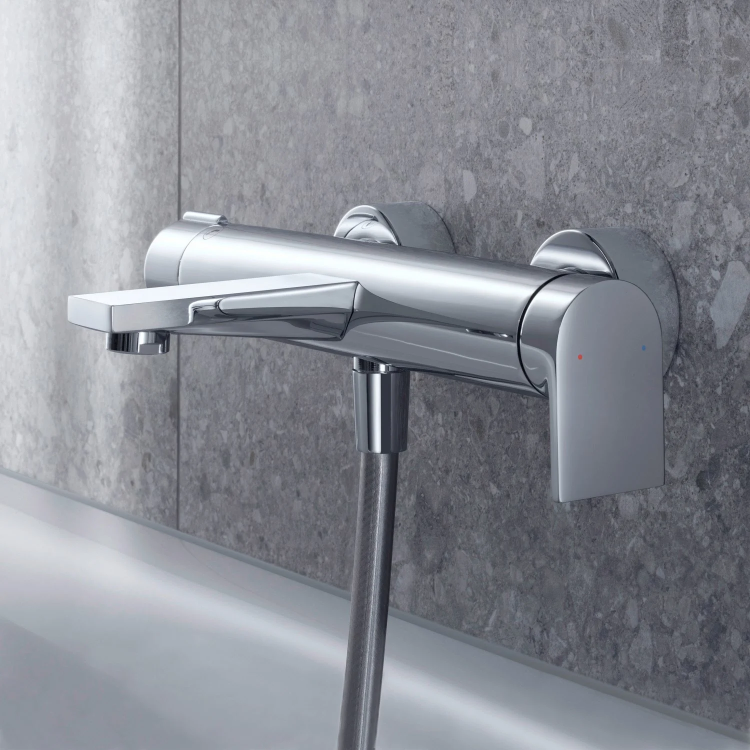 Chromowana bateria wannowa na szarej ścianie, Duravit