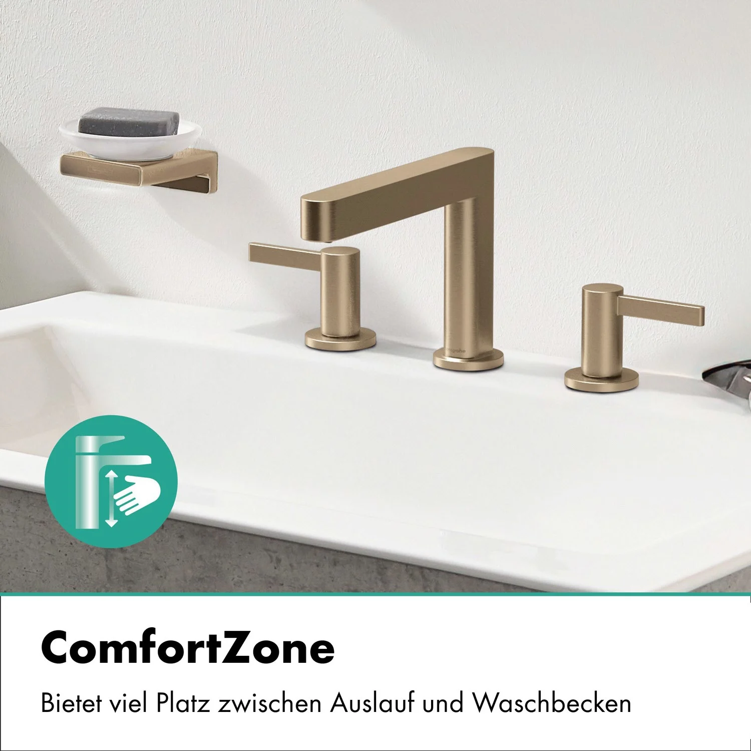 Złota bateria trzyotworowa na białej umywalce, hansgrohe