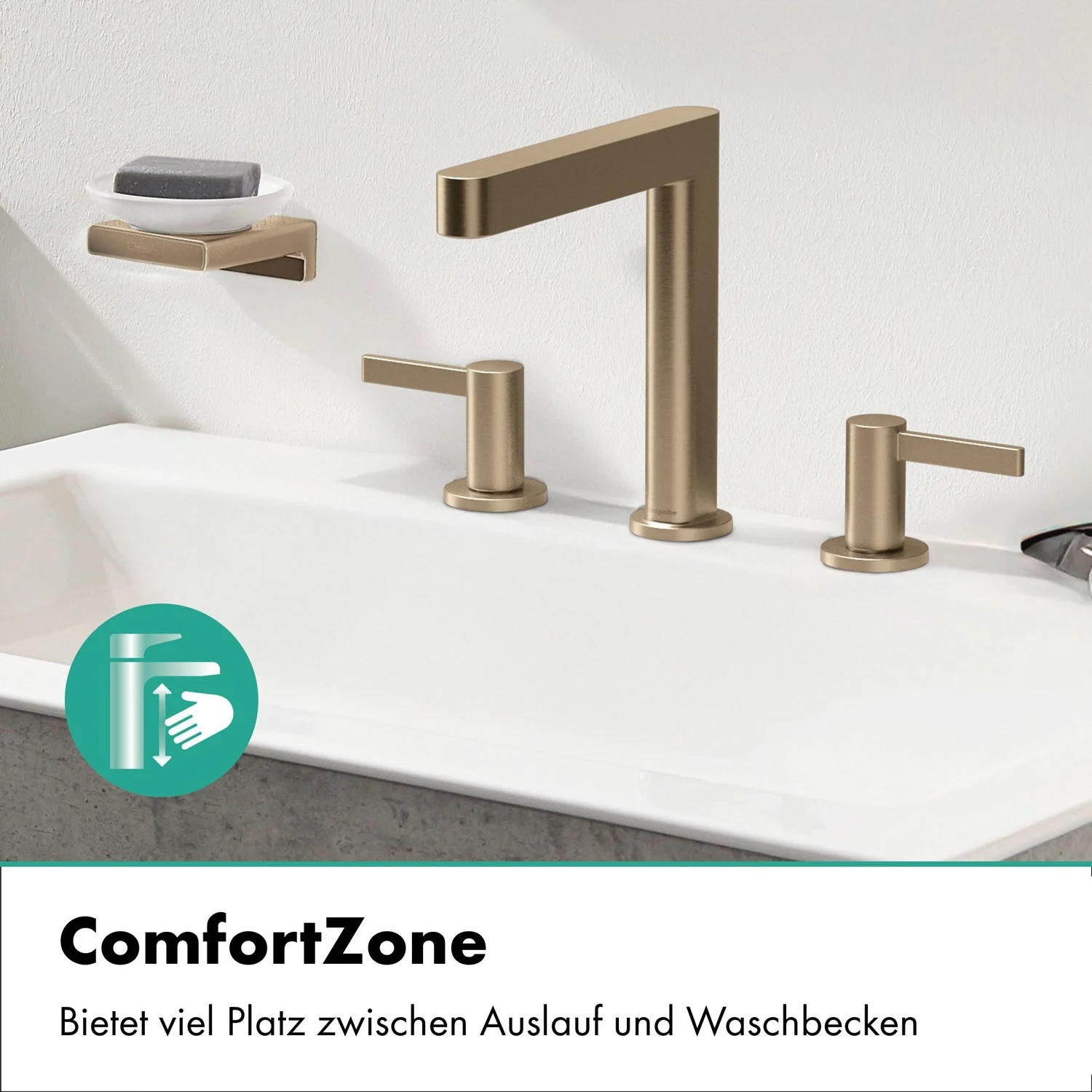 Złota bateria trzyotworowa na białej umywalce, hansgrohe
