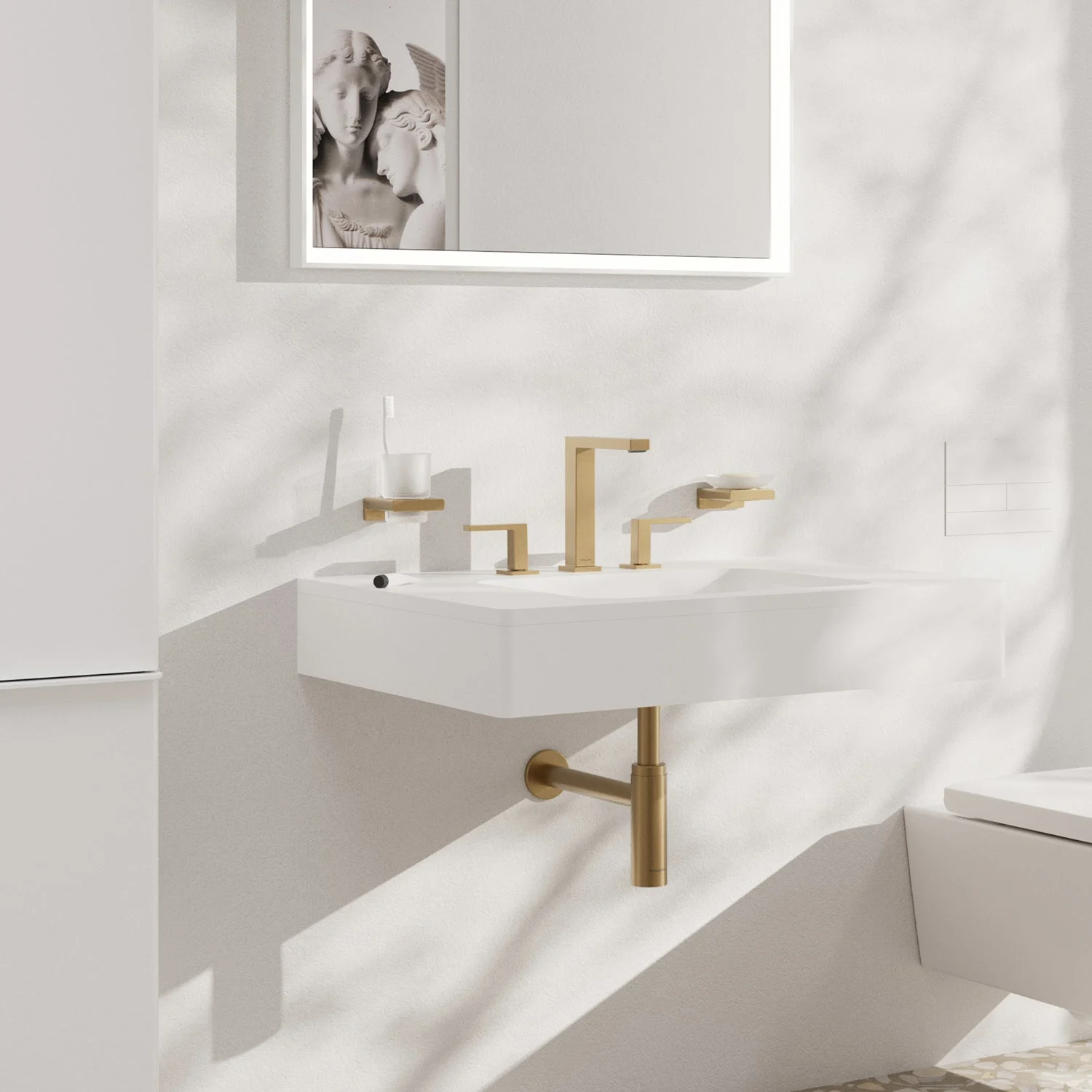 Złota bateria 3-otworowa na białej umywalce, hansgrohe