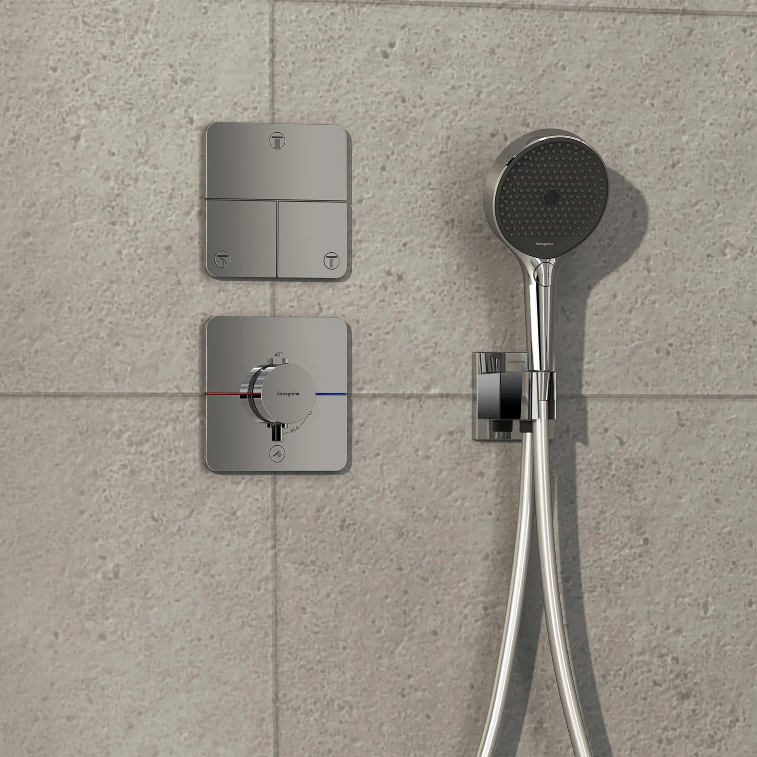 Chromowana armatura prysznicowa na szarej ścianie z płytek, hansgrohe
