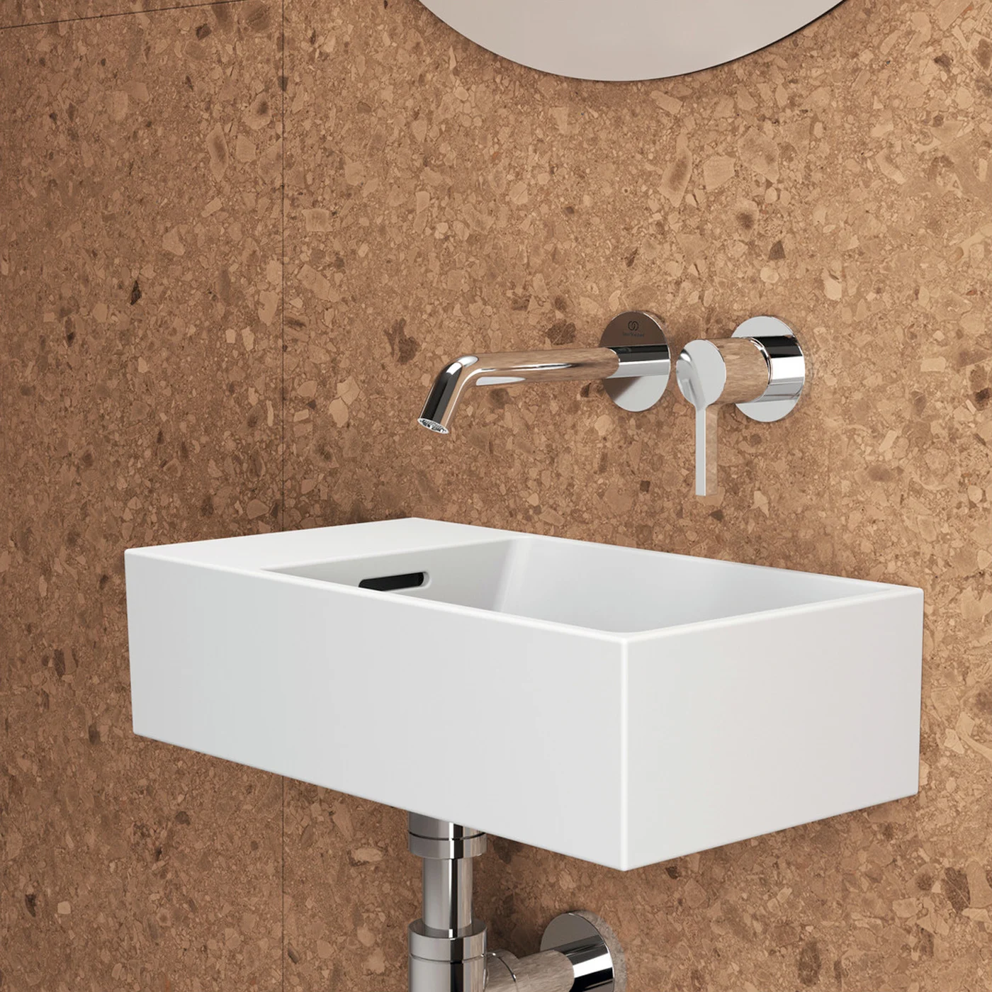 Biała umywalka z baterią ścienną na tle korkowej ściany, Ideal Standard