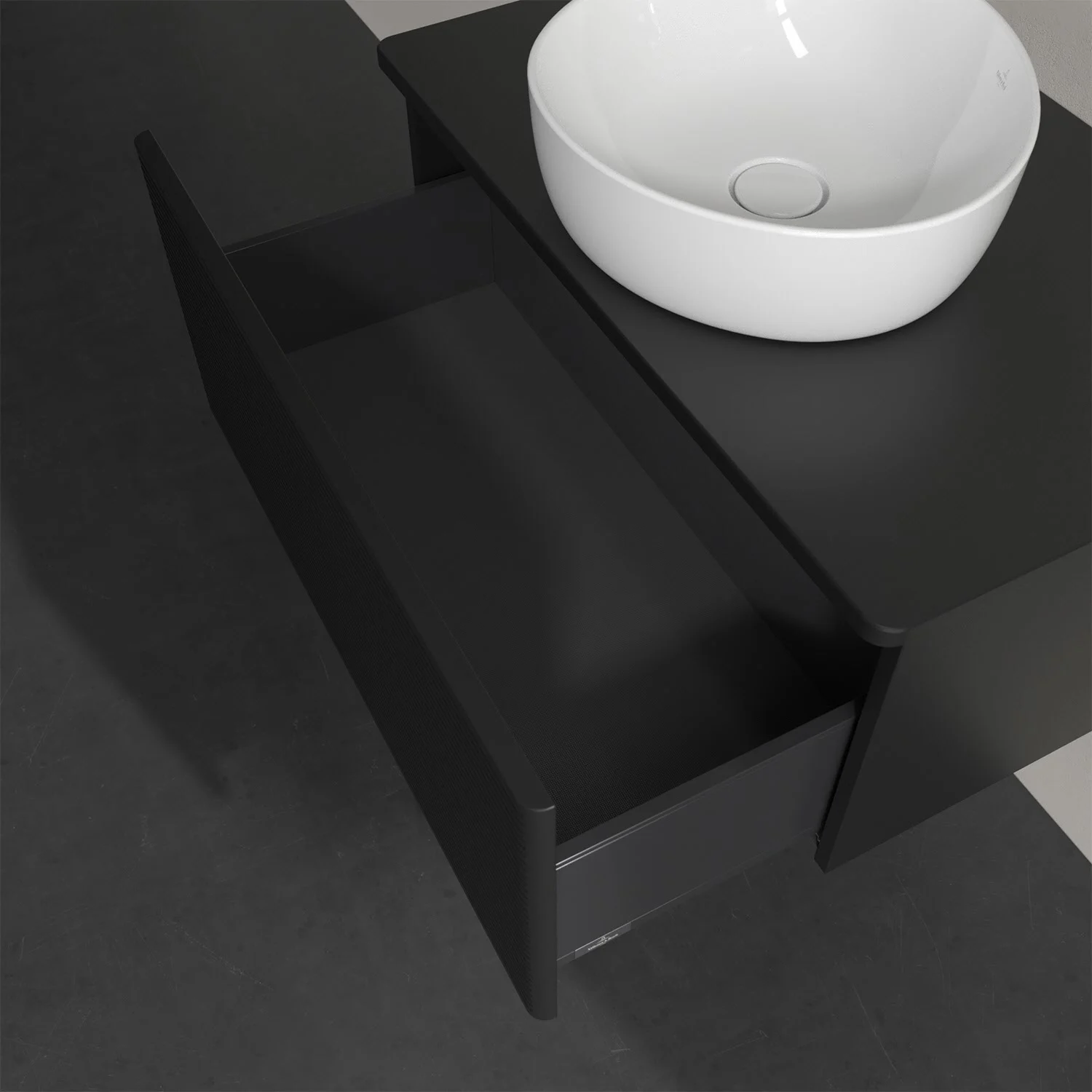 Otwarta szuflada z białą umywalką na ciemnym blacie, Villeroy & Boch