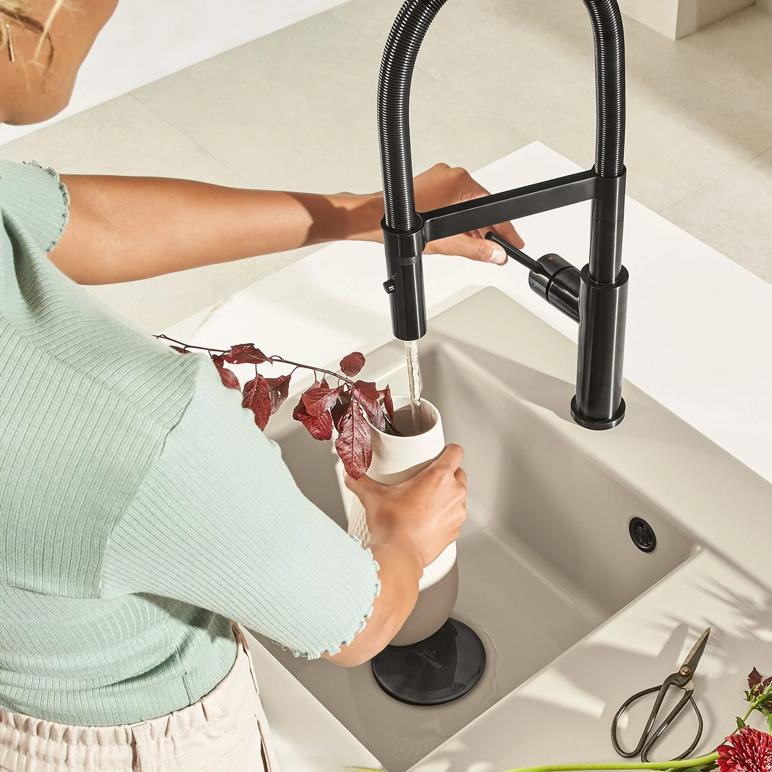 Osoba napełnia wazon w ceramicznym zlewie, Villeroy & Boch