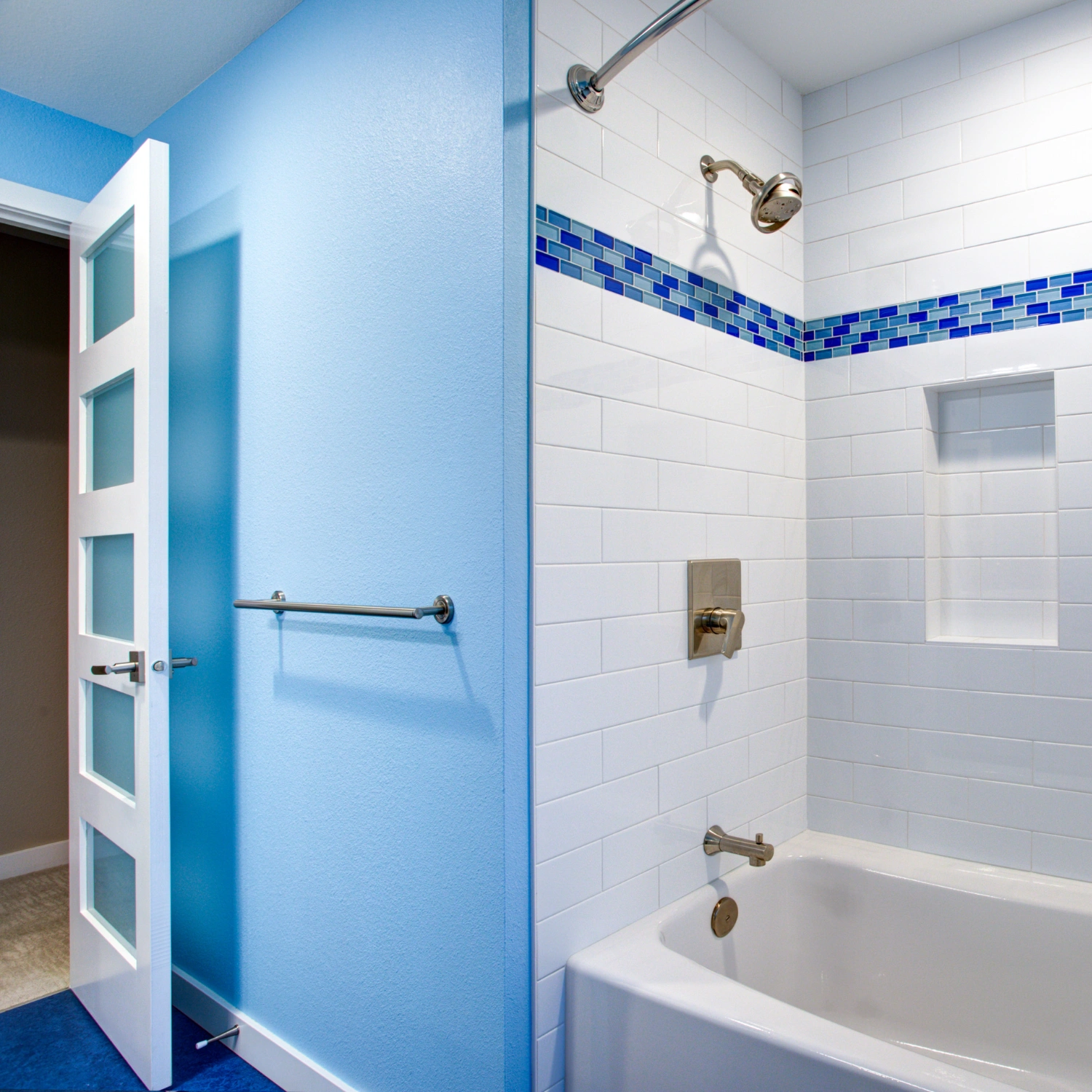 Holztür mit Glaseinsätzen in blau gestaltetem Badezimmer